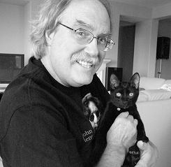 Douglas holding a black cat